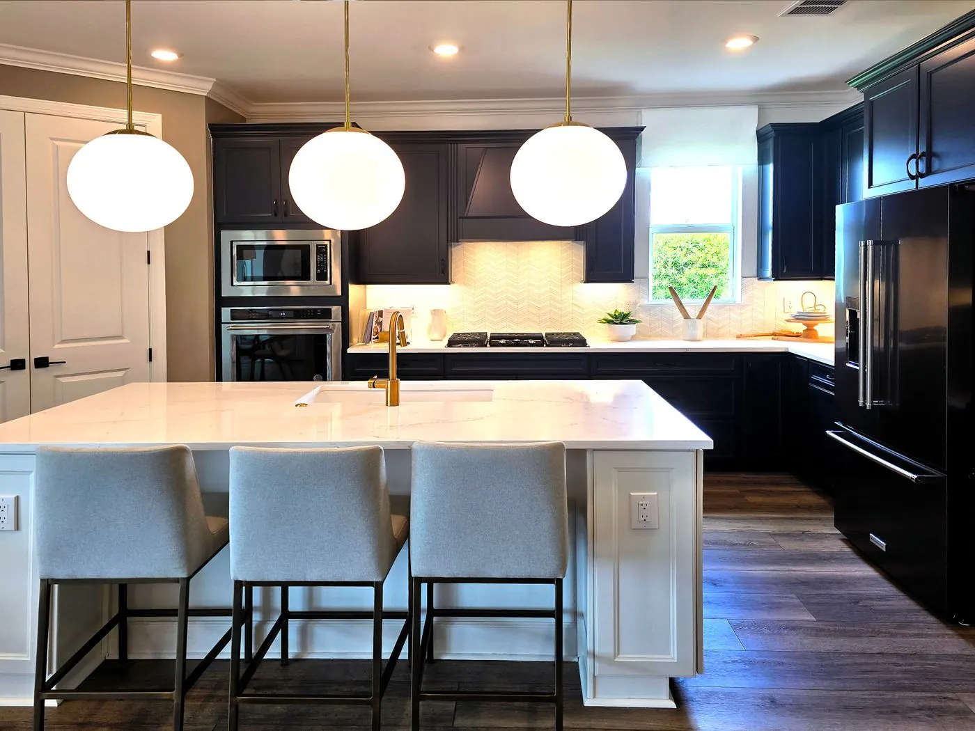 Contemporary kitchen with pendant lights and a central island